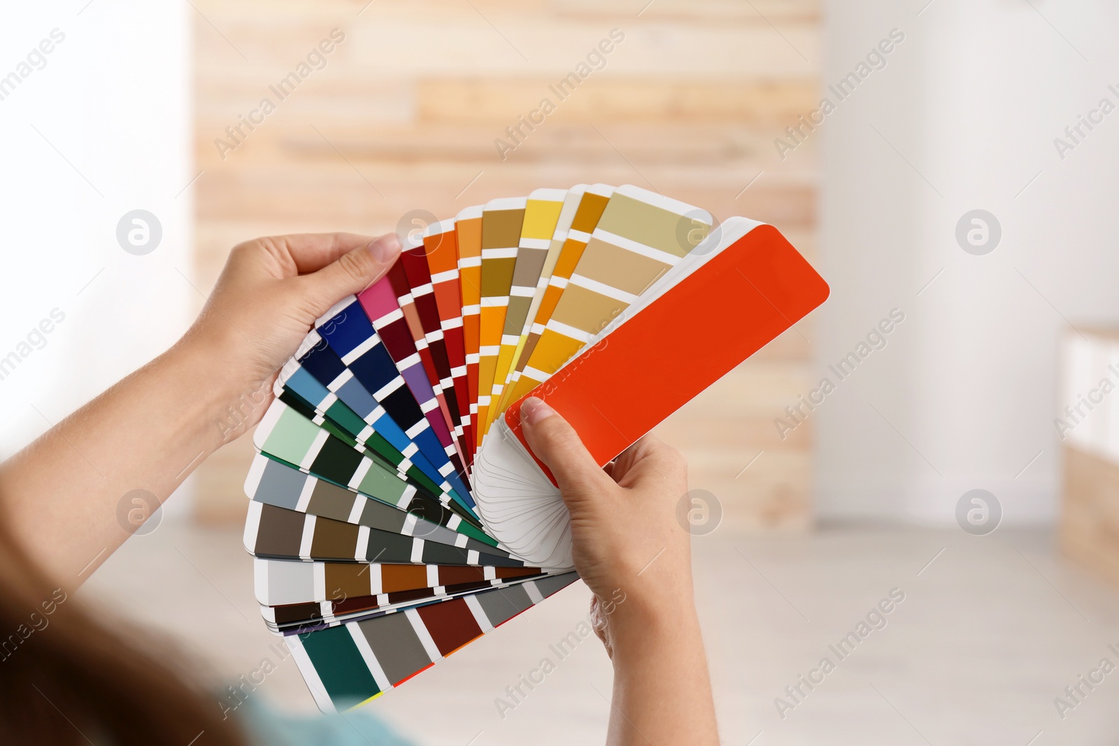 Photo of Female interior designer with color palette samples indoors, closeup