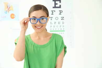 Photo of Young woman with glasses visiting ophthalmologist