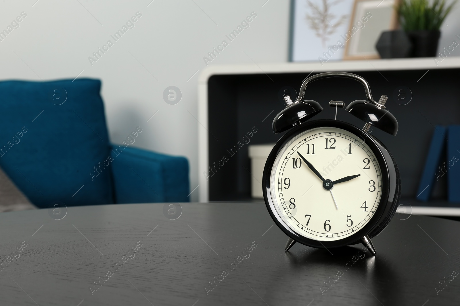 Photo of Alarm clock on table indoors, space for text. Time management