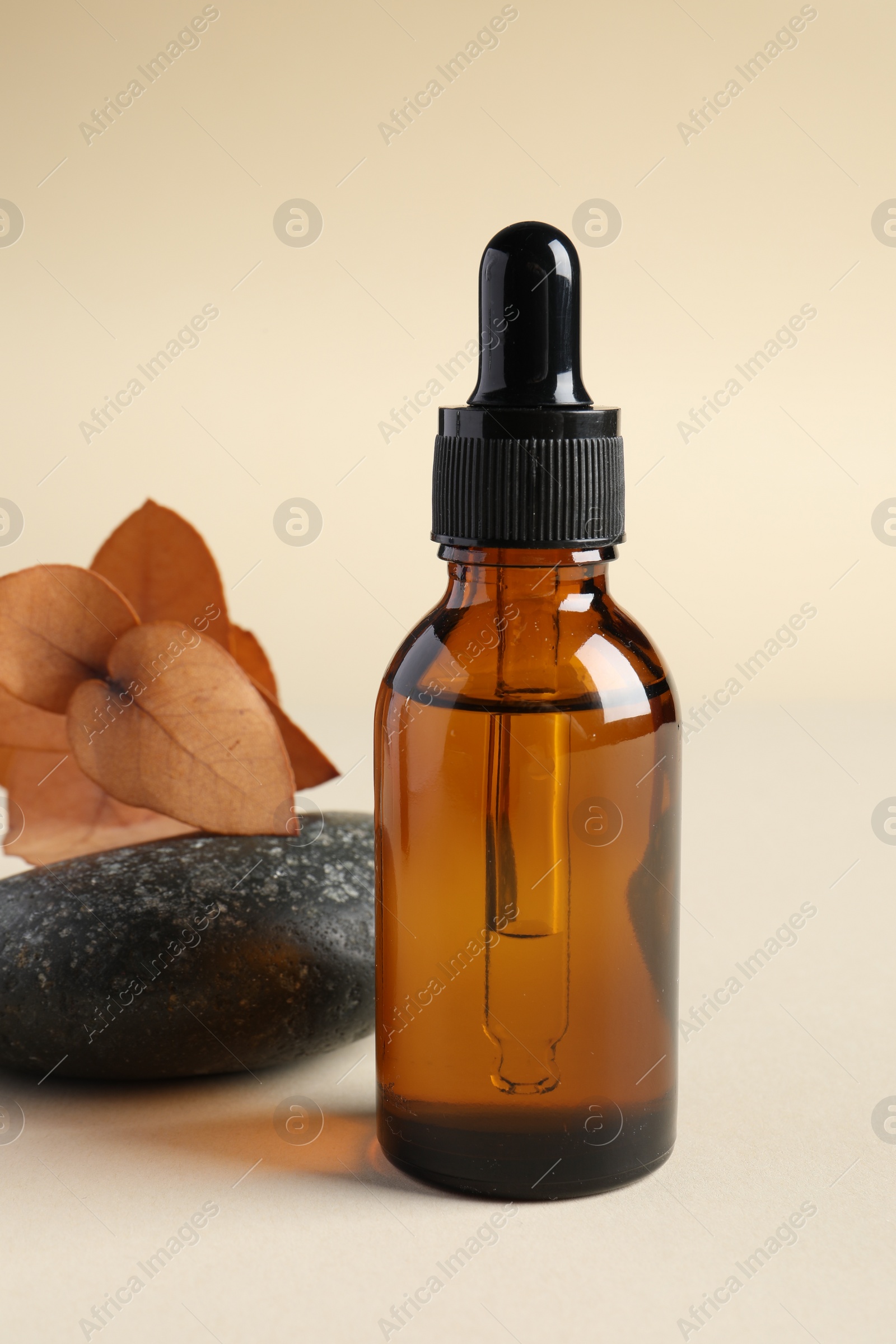 Photo of Composition with bottle of cosmetic serum on beige background