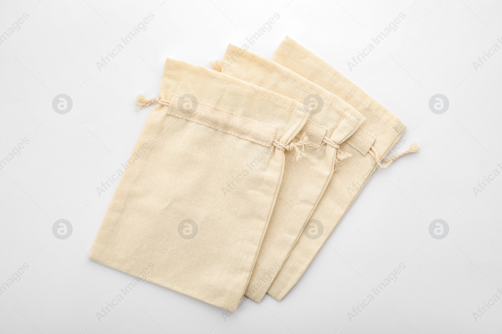 Photo of Cotton eco bags isolated on white, top view