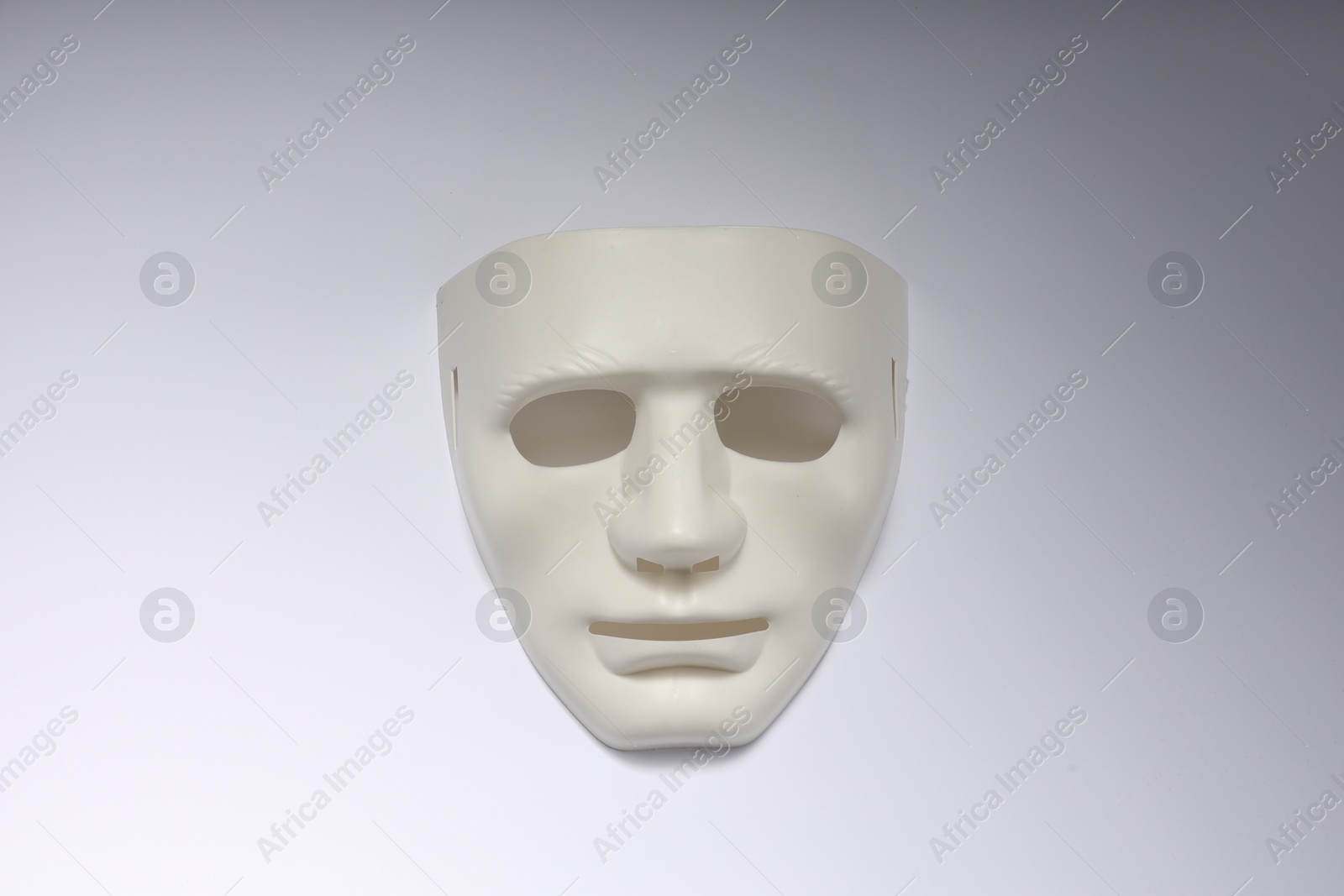 Photo of Theater arts. Plastic mask on white background, top view