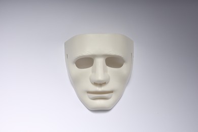 Theater arts. Plastic mask on white background, top view