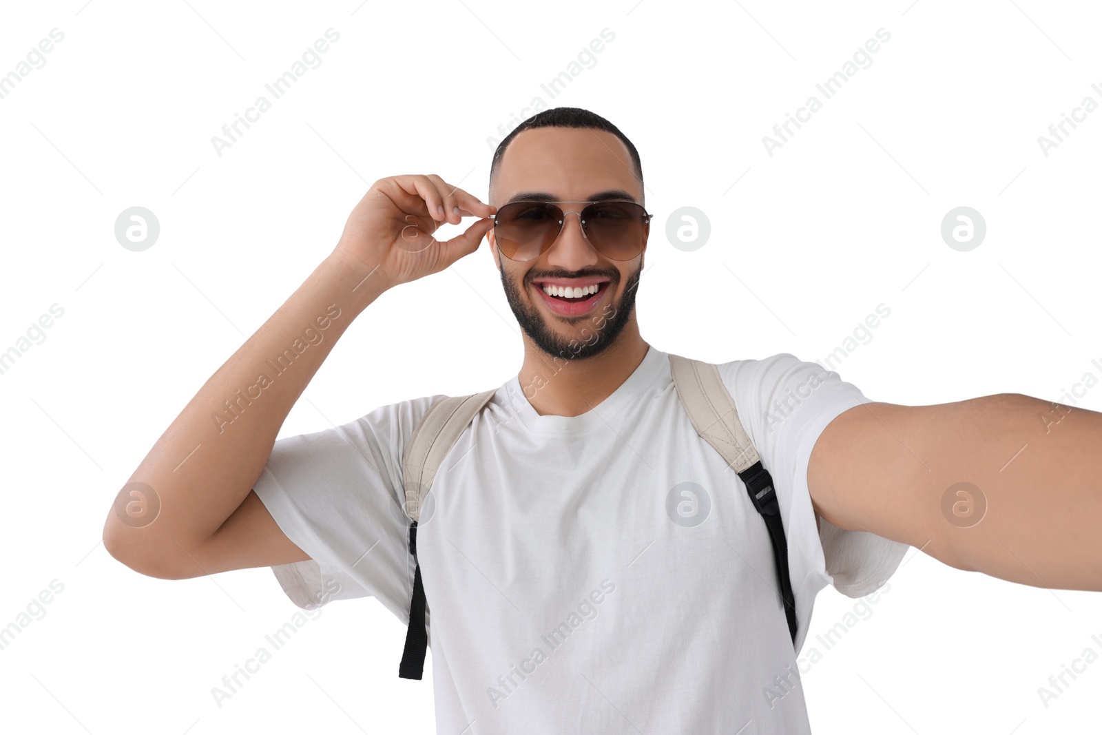 Photo of Smiling young man in sunglasses taking selfie on white background