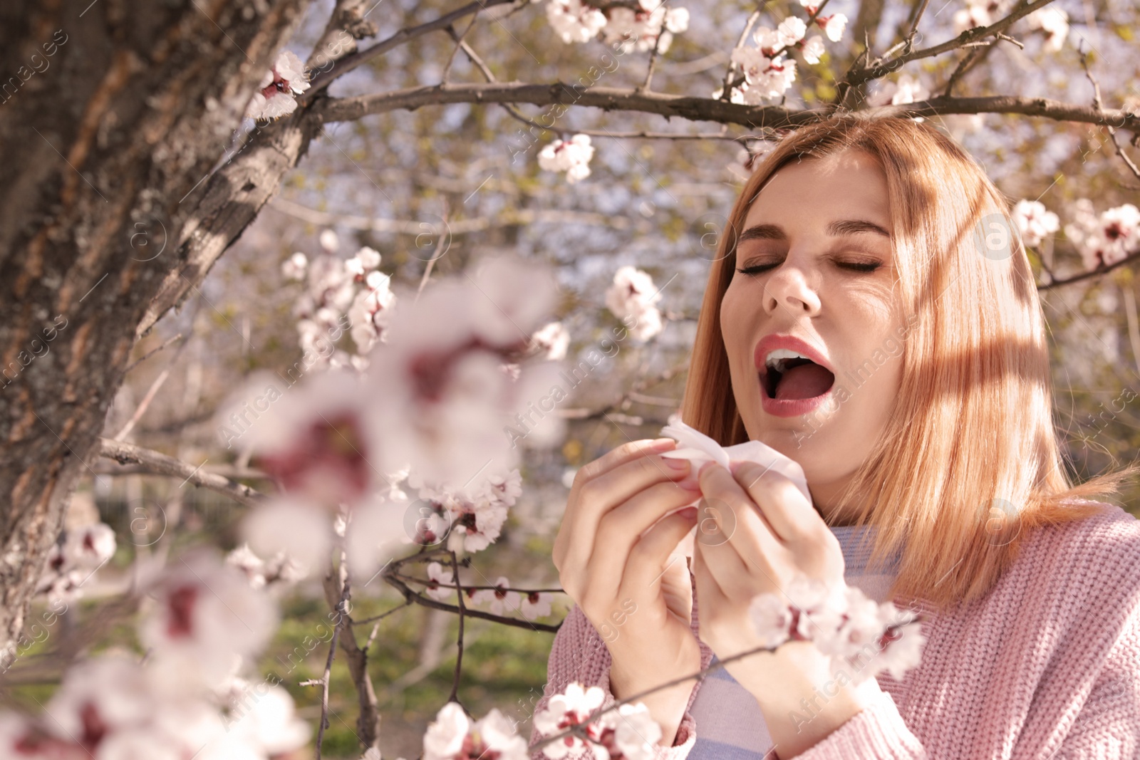 Photo of Woman suffering from seasonal allergy outdoors on sunny day