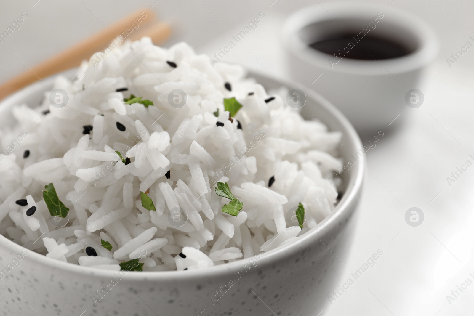 Photo of Bowl of tasty cooked rice served on table, closeup