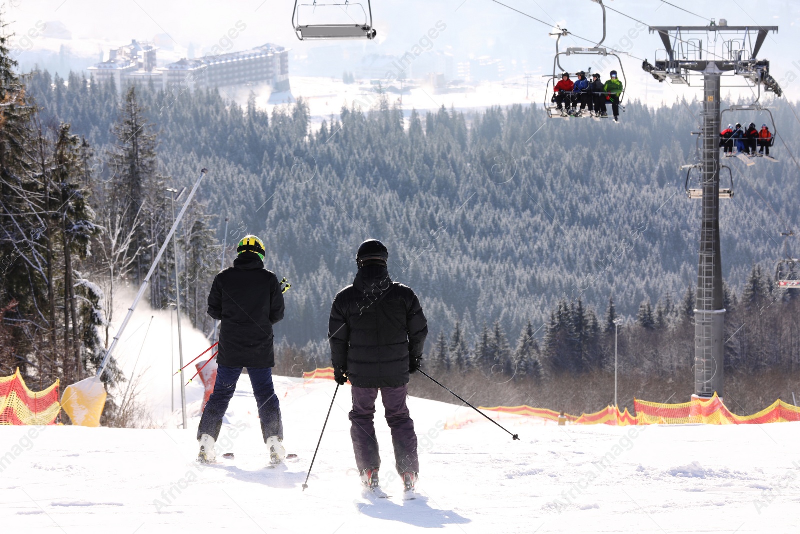 Photo of People skiing on snowy hill in mountains. Winter vacation