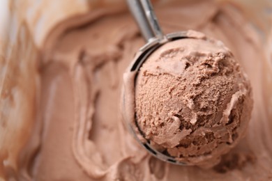 Photo of Taking tasty chocolate ice cream with scoop as background, closeup. Space for text