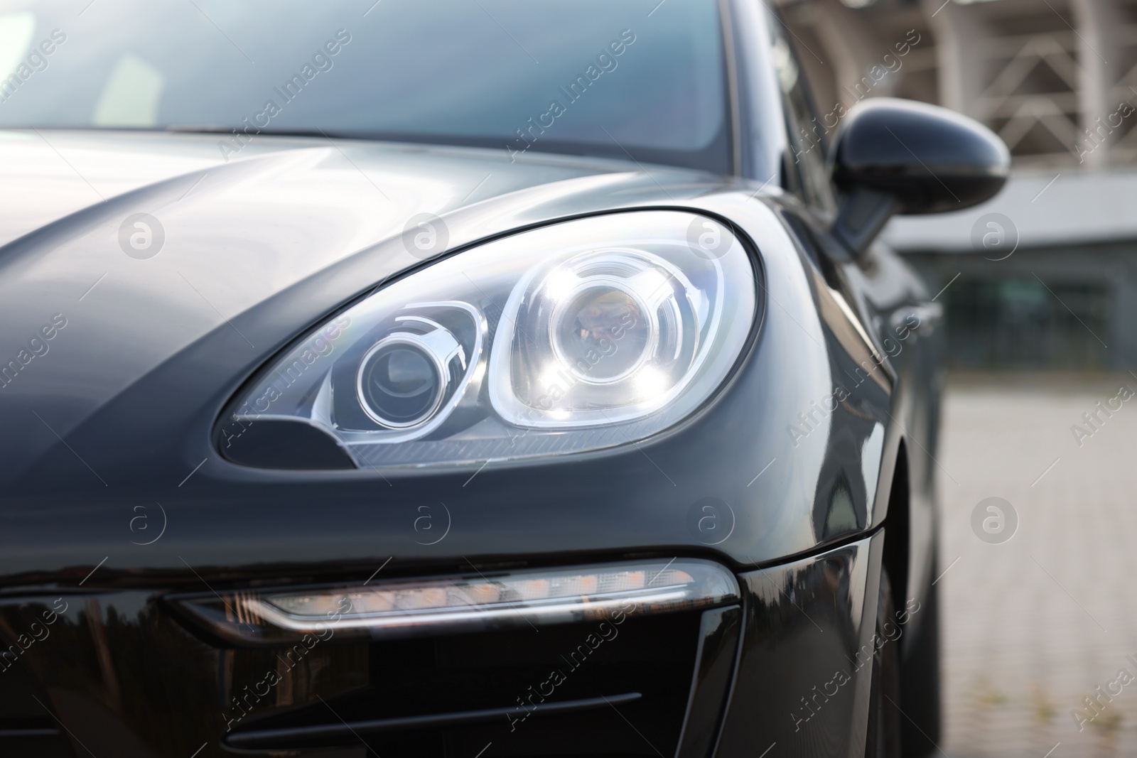 Photo of Modern black car parked outdoors, closeup view