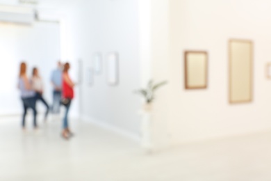 People in modern art gallery, blurred view