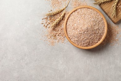 Photo of Wheat bran on light table, flat lay. Space for text