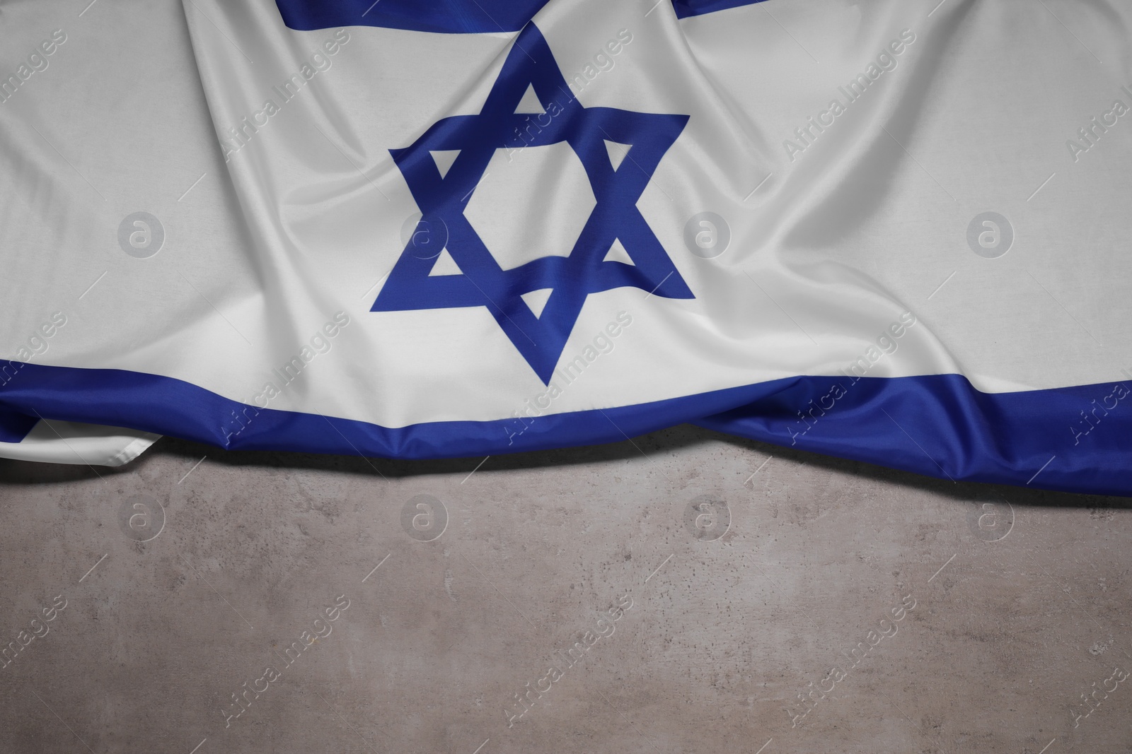 Photo of Flag of Israel on grey background, top view and space for text. National symbol