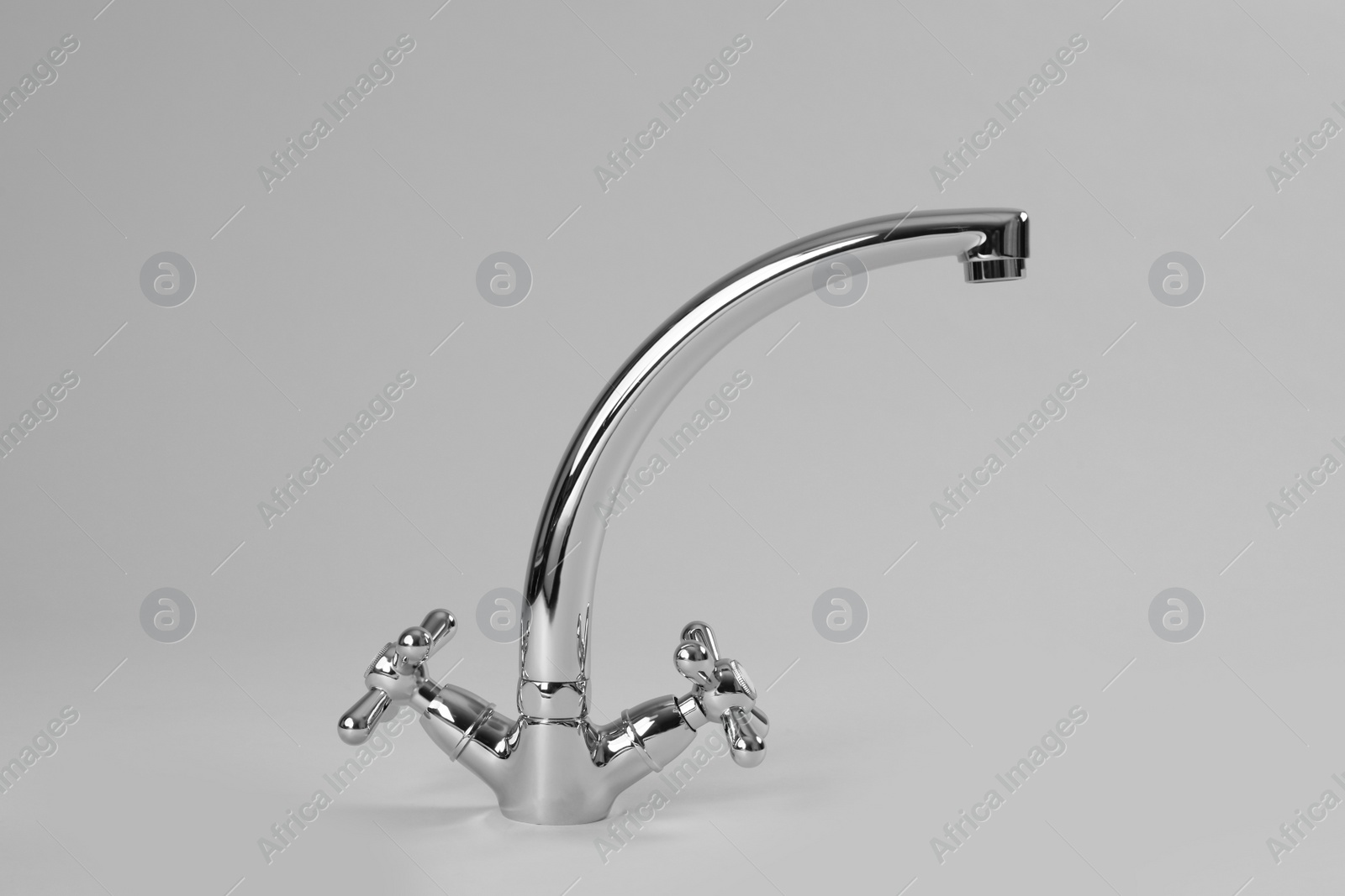 Photo of Double handle water tap on grey background