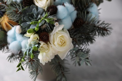 Photo of Beautiful wedding winter bouquet on light background, closeup