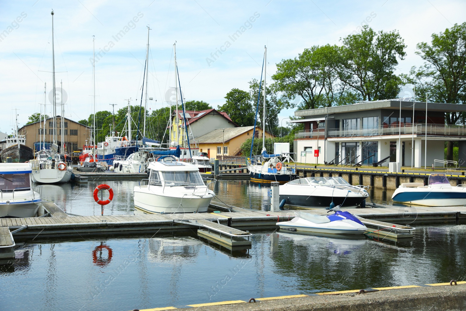 Photo of Beautiful view of city pier with modern boats