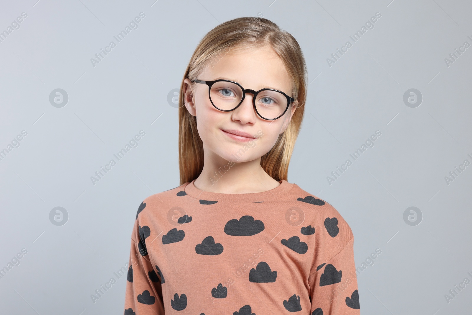 Photo of Portrait of cute girl in glasses on light grey background