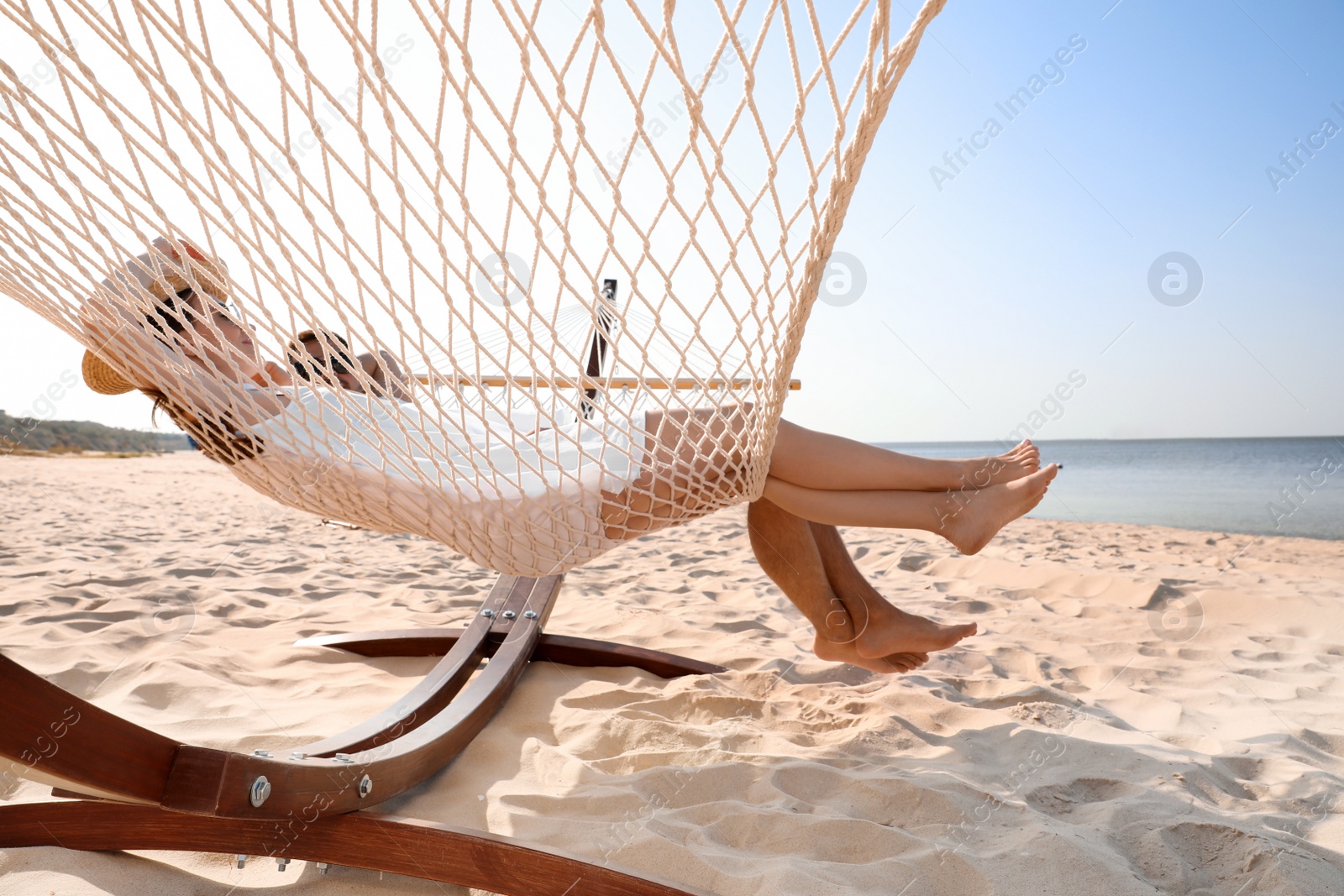 Photo of Young lovely relaxing in hammock on beach