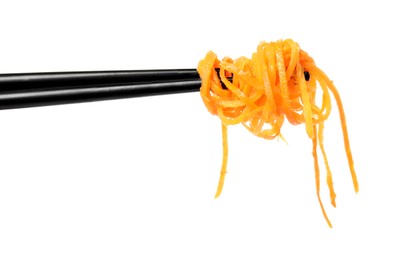 Photo of Chopsticks with delicious Korean carrot salad on white background