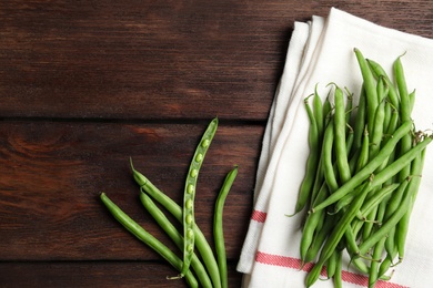 Fresh green beans on wooden table, flat lay. Space for text