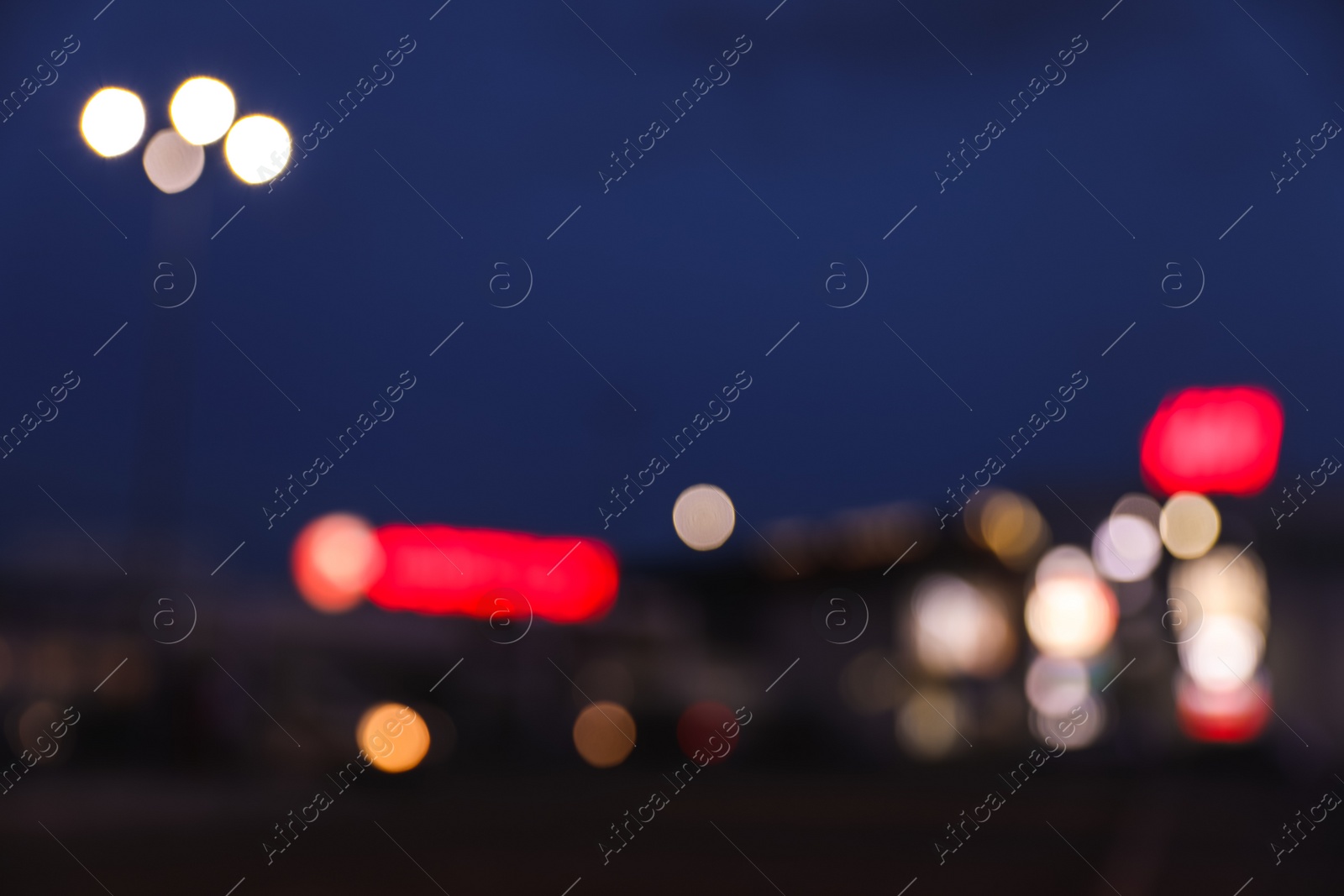 Photo of Blurred view of modern city at night. Bokeh effect