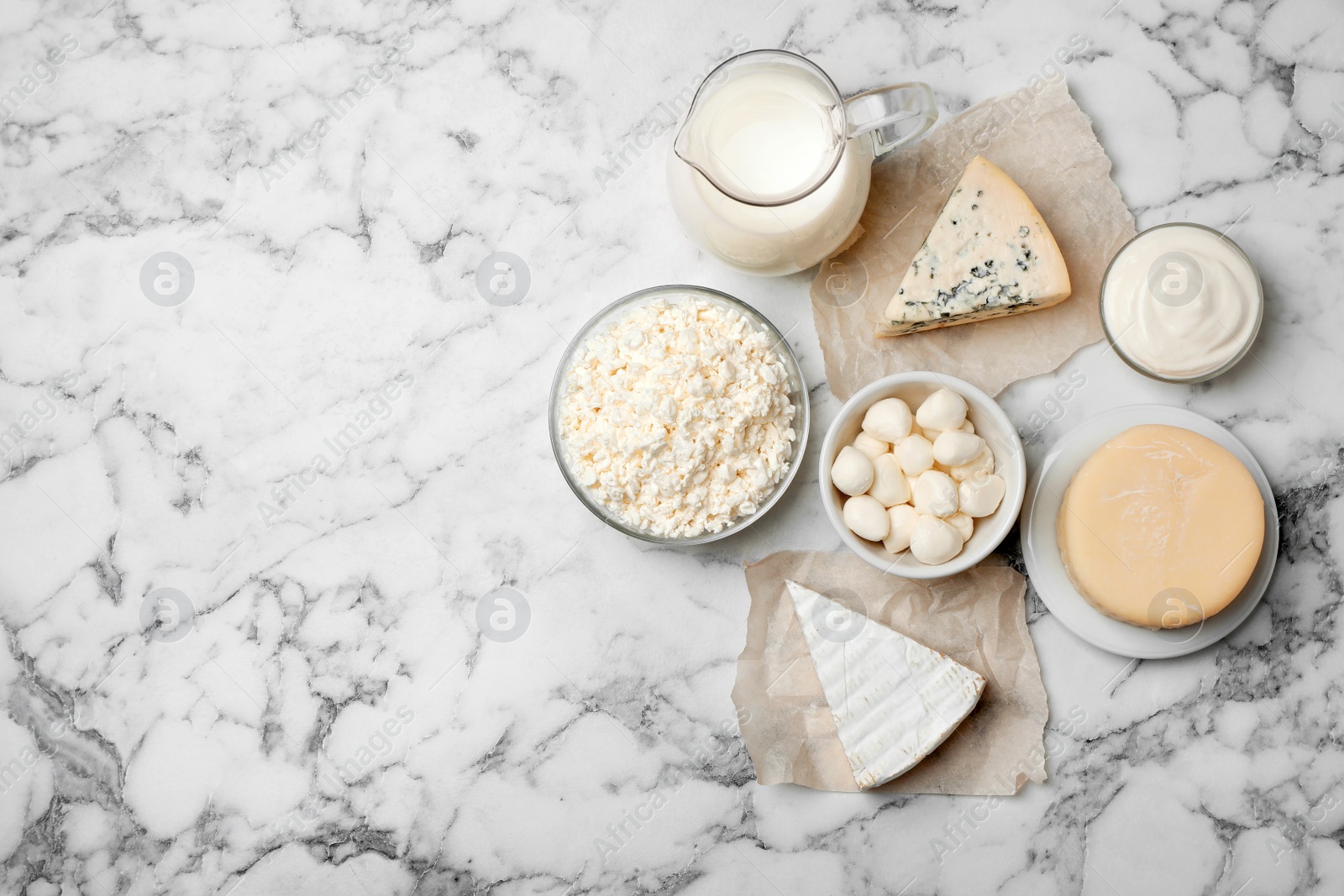 Photo of Different dairy products on light background, flat lay