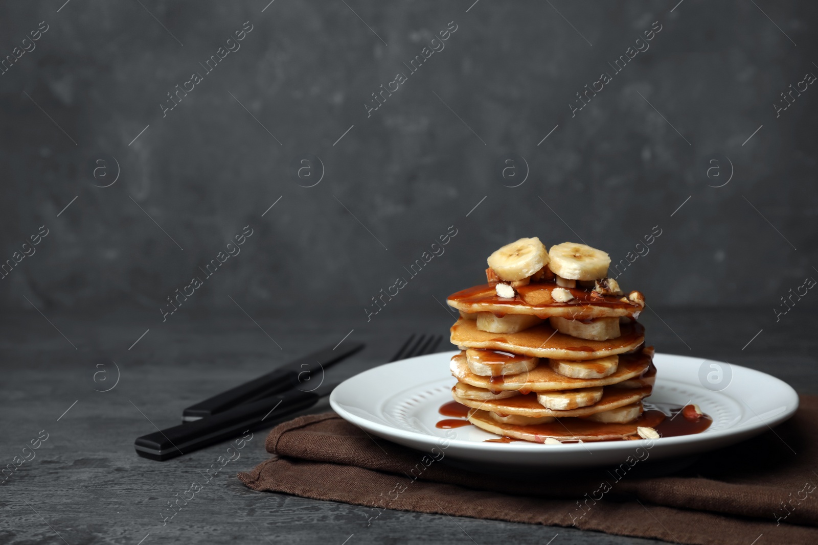 Photo of Plate with delicious pancakes on table