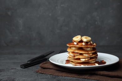 Plate with delicious pancakes on table