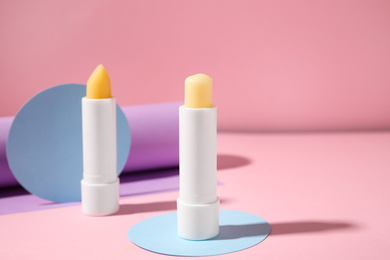 Composition with hygienic lipsticks on pink background