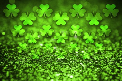 Image of St. Patrick's Day greeting card design with clover leaves, bokeh effect