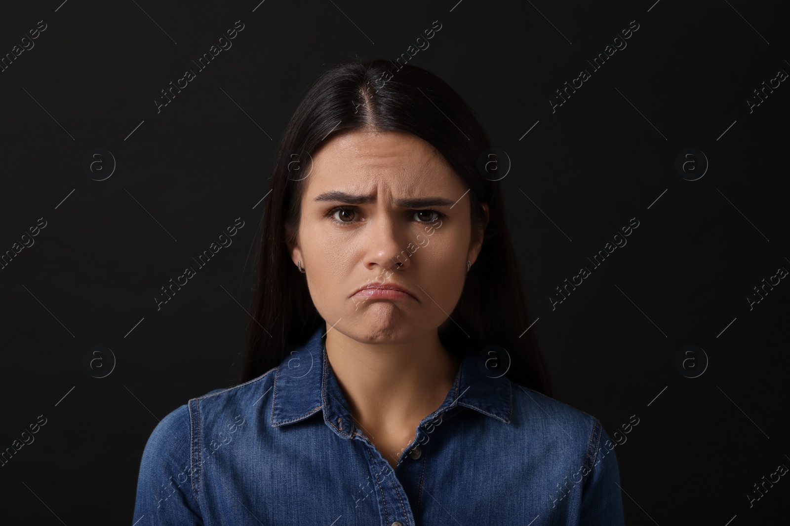 Photo of Personality concept. Emotional woman on black background