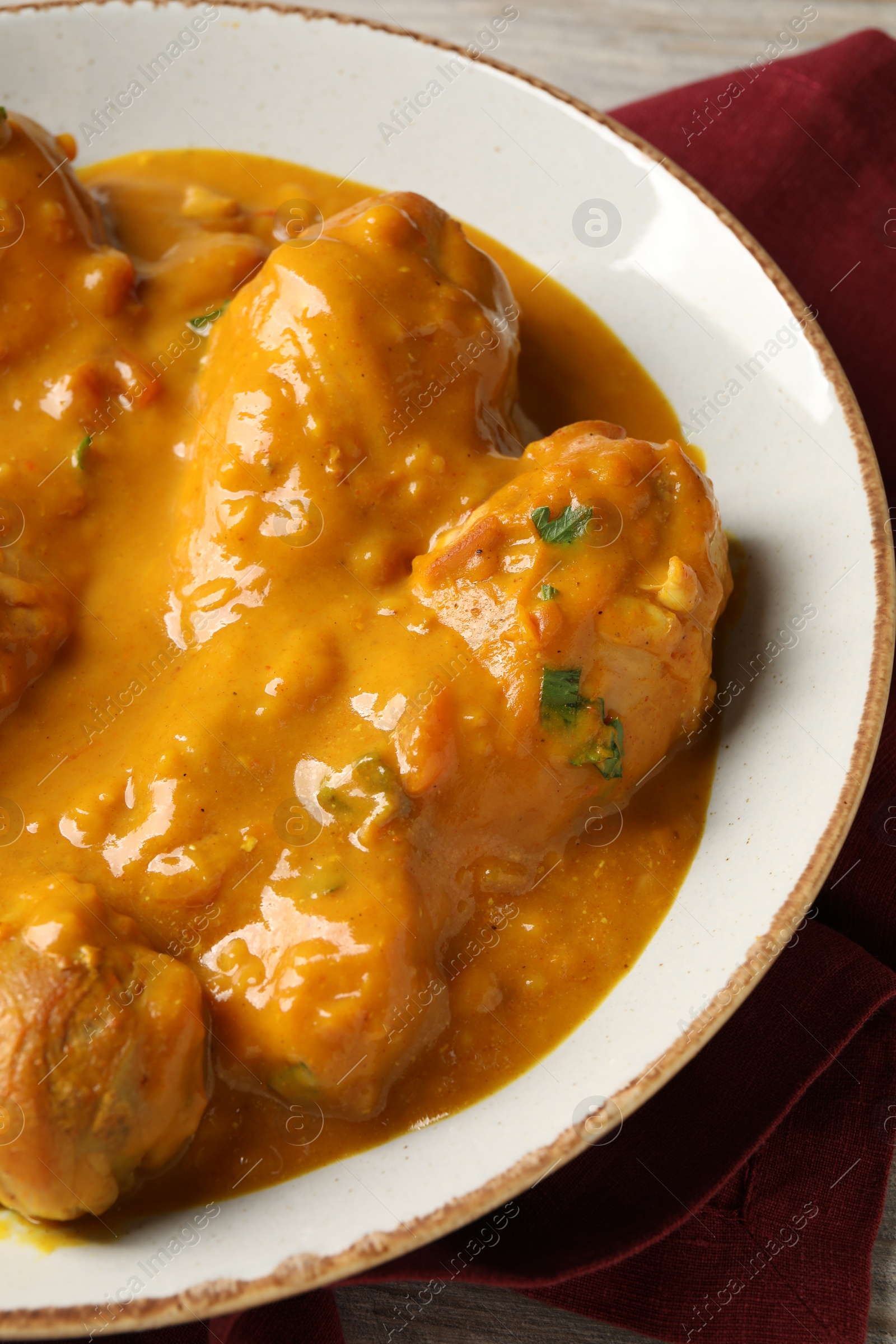 Photo of Tasty fresh chicken curry on wooden table