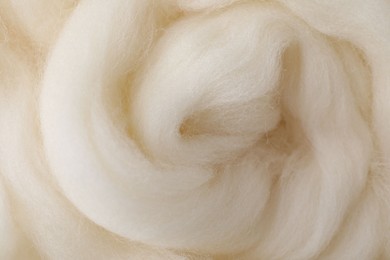 White felting wool as background, closeup view