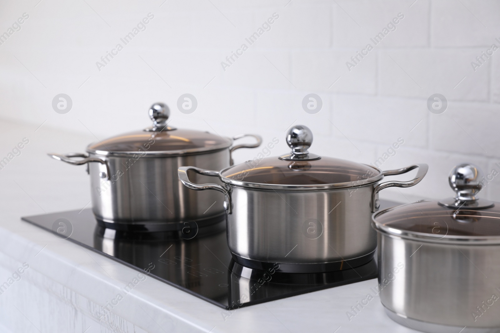 Photo of Set of new clean cookware in kitchen