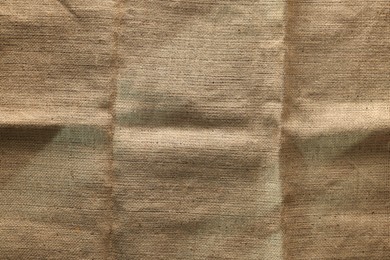 Photo of Texture of natural burlap fabric as background, top view