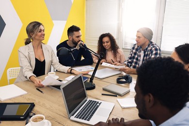 Photo of Team of employees working together in office. Startup project