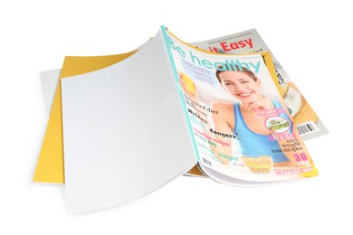 Stack of different magazines on white background