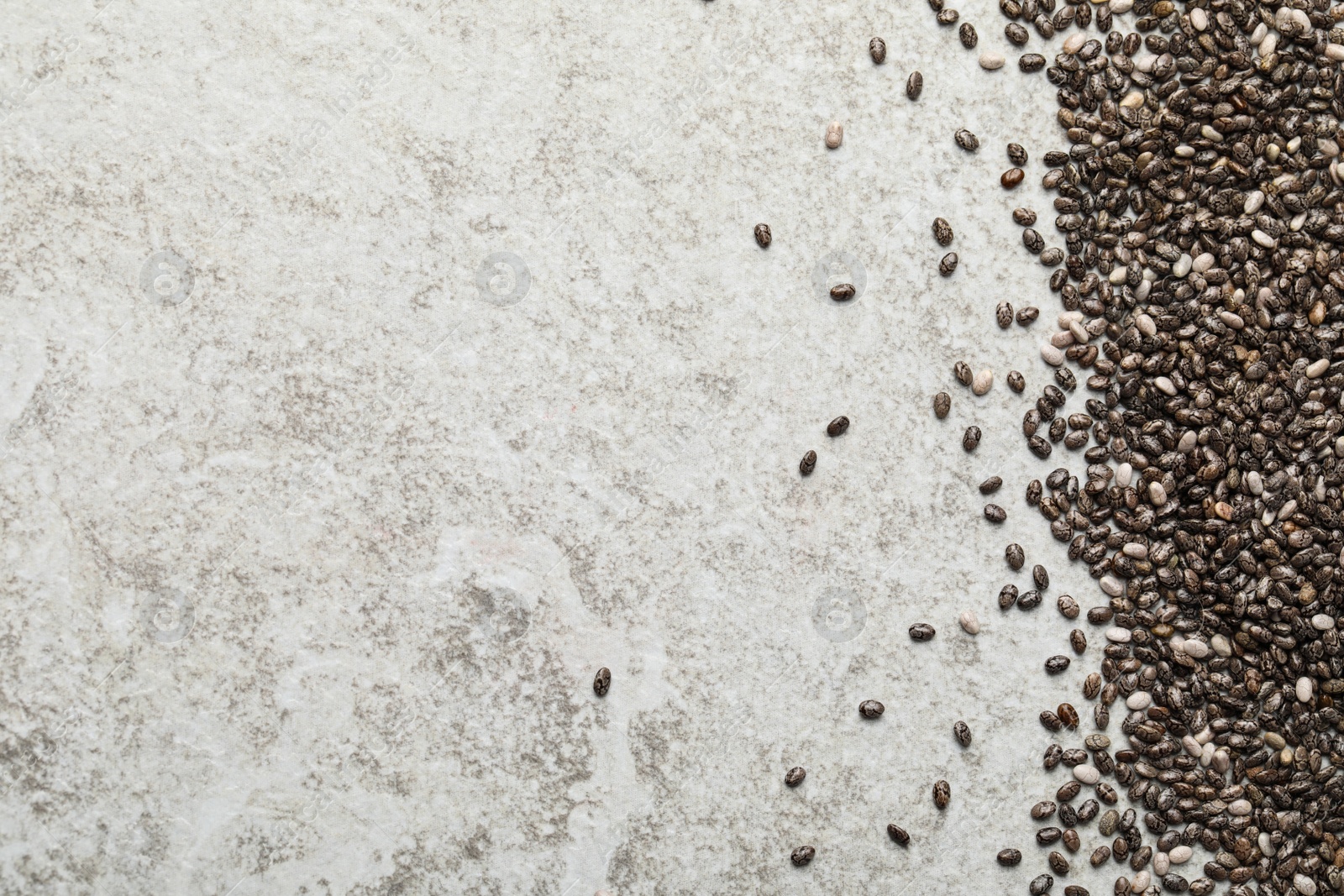 Photo of Pile of chia seeds on light grey table, flat lay. Space for text