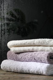 Photo of Stacked terry towels on table in bathroom