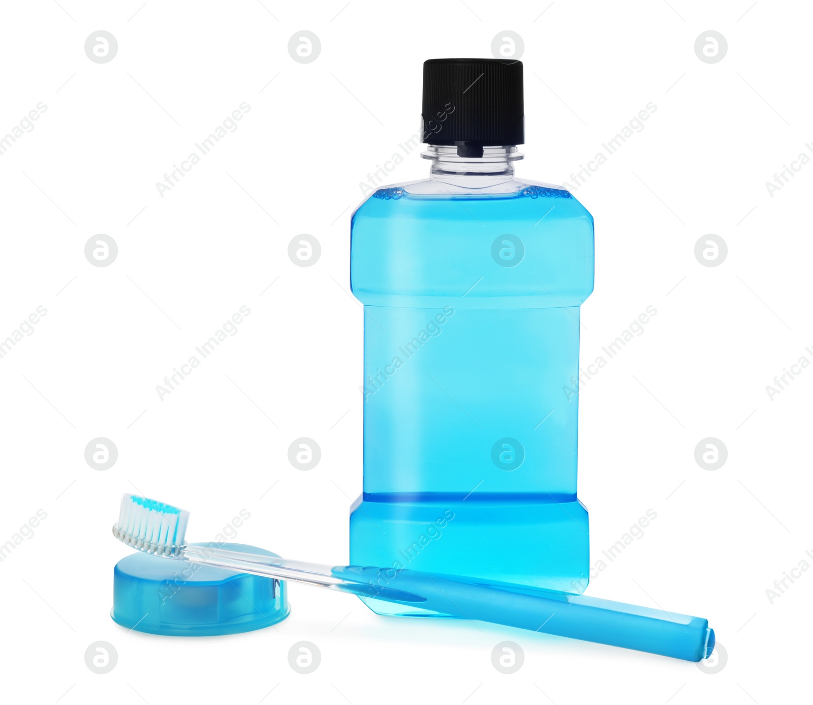 Photo of Bottle with mouthwash, dental floss and toothbrush on white background