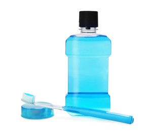 Photo of Bottle with mouthwash, dental floss and toothbrush on white background