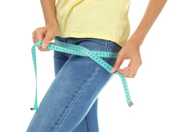 Photo of Young slim woman with measuring tape on white background. Weight loss diet