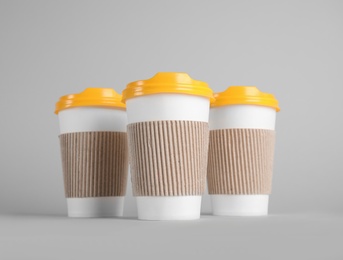 Photo of Carton cups on grey background. Mock up for design