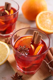 Photo of Aromatic punch drink and ingredients on table