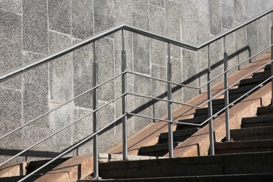 Photo of Staircase and ramp with metal handrail near building outdoors