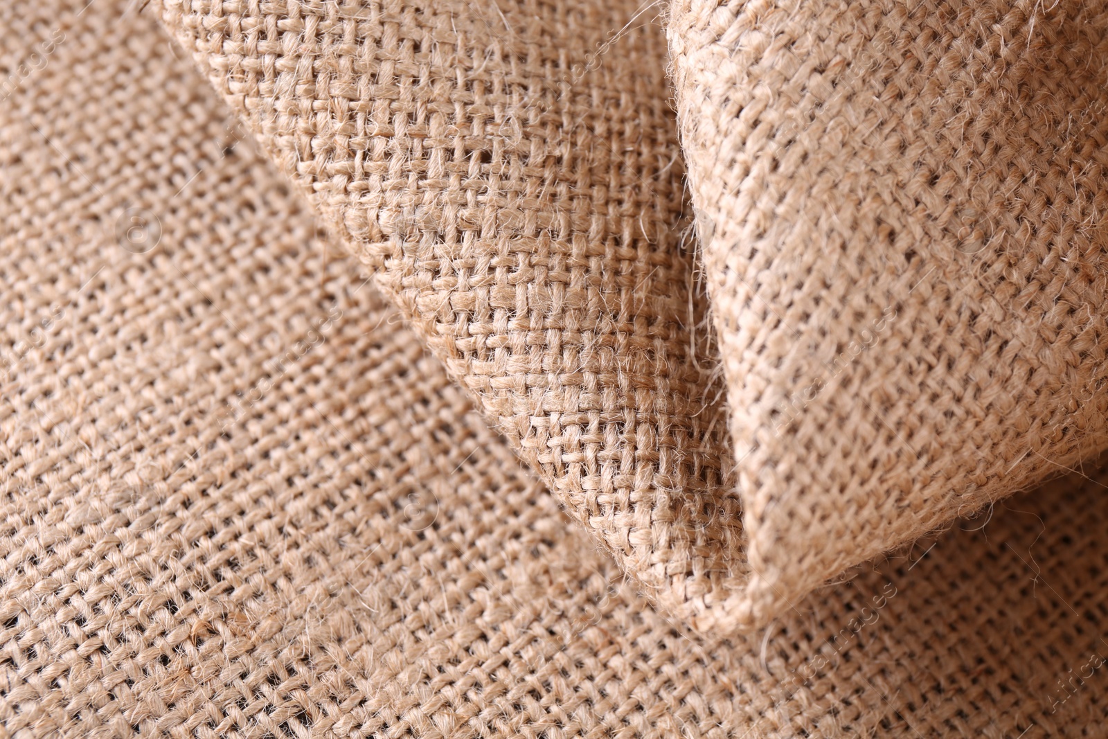 Photo of Texture of beige burlap fabric, closeup view