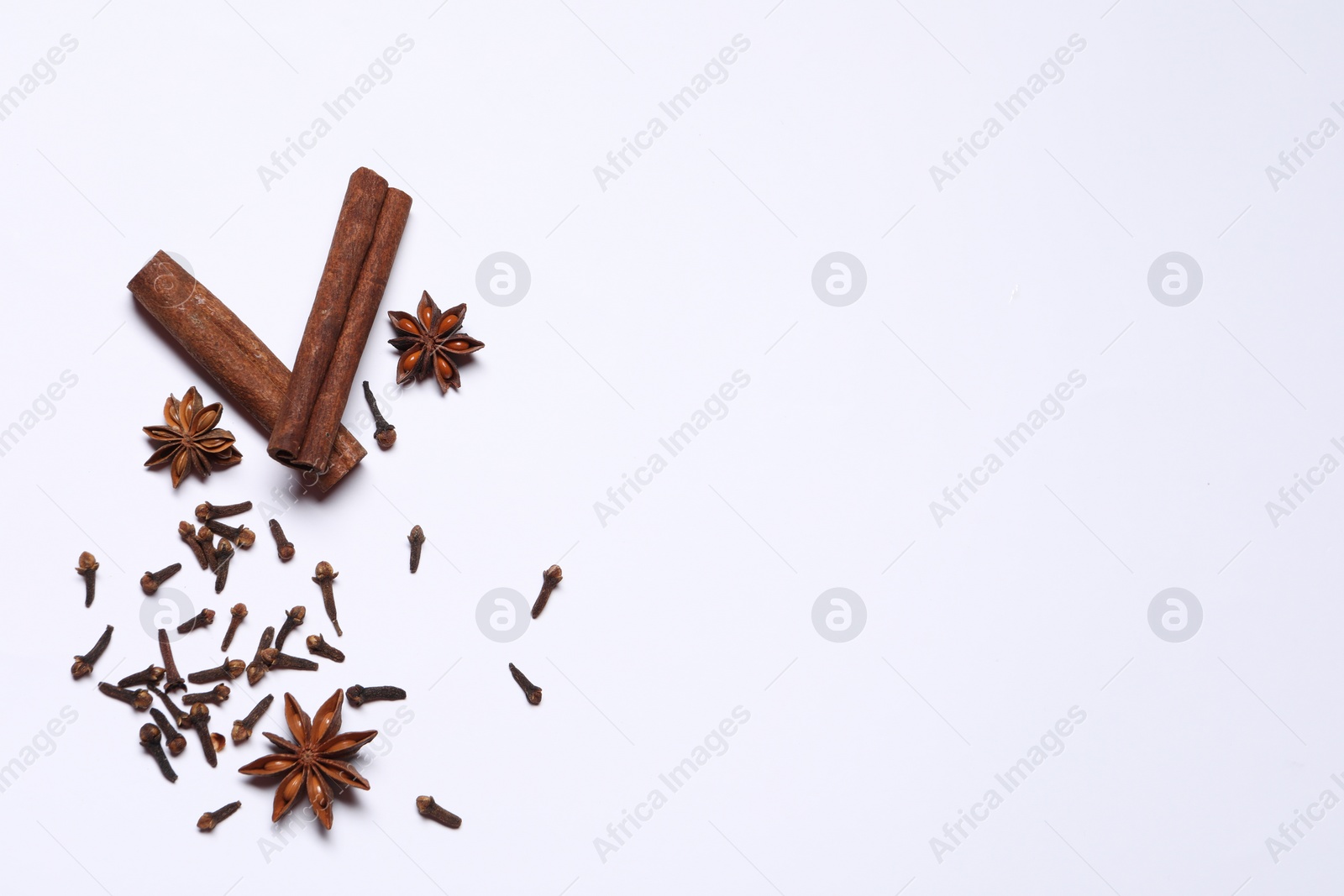 Photo of Different spices on white table, flat lay. Space for text