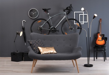 Stylish room interior with bicycle and sofa