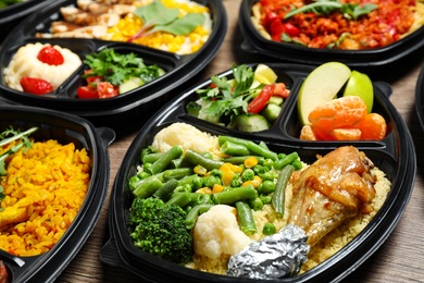 Photo of Lunchboxes with different meals on table. Healthy food delivery