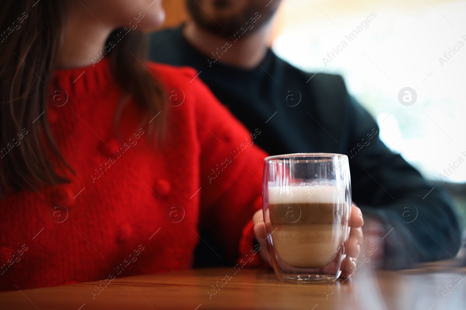 Photo of Lovely couple with fresh aromatic coffee at table in cafe, closeup