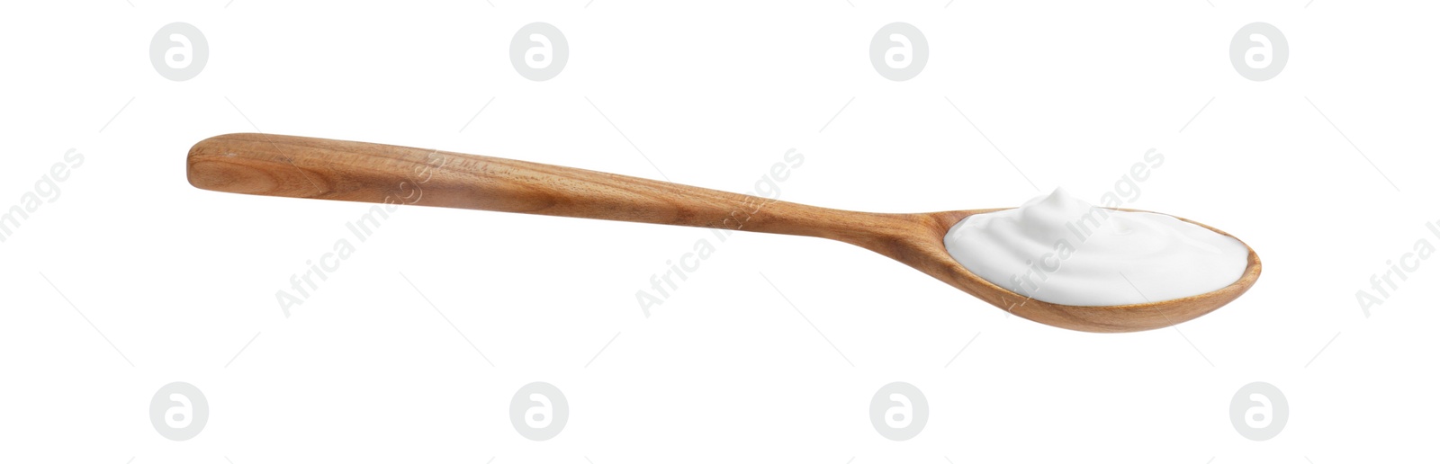 Photo of One wooden spoon with sour cream isolated on white